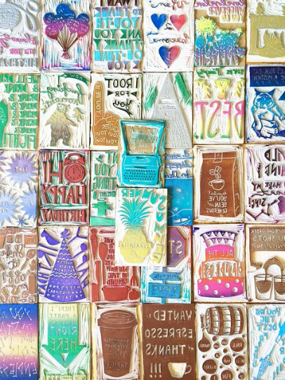 a mosaic of hand-carved stamps in many different colors and designs. made by hand and inspired by song lyrics.